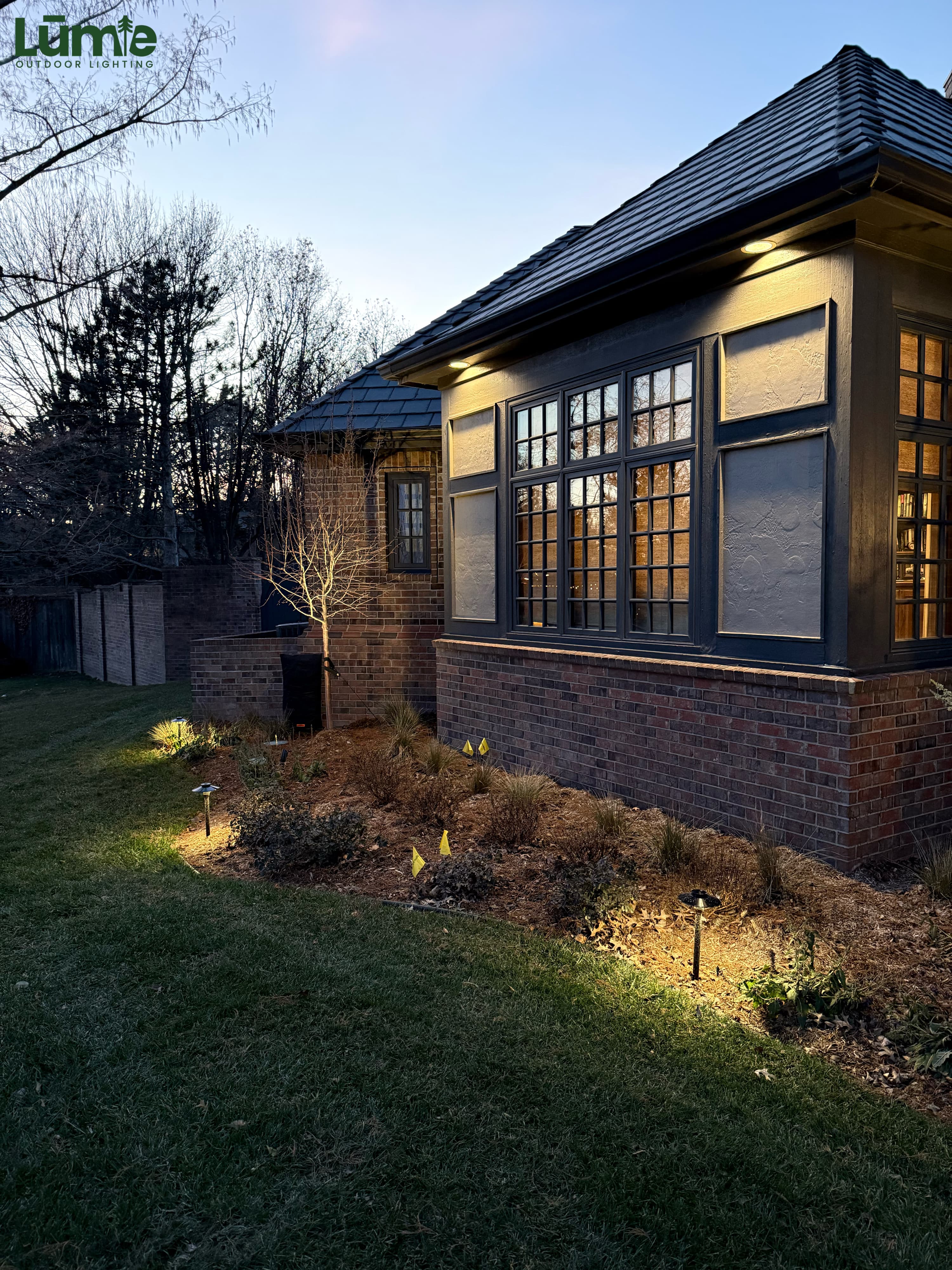 Side facade with masonry uplighting and path lights