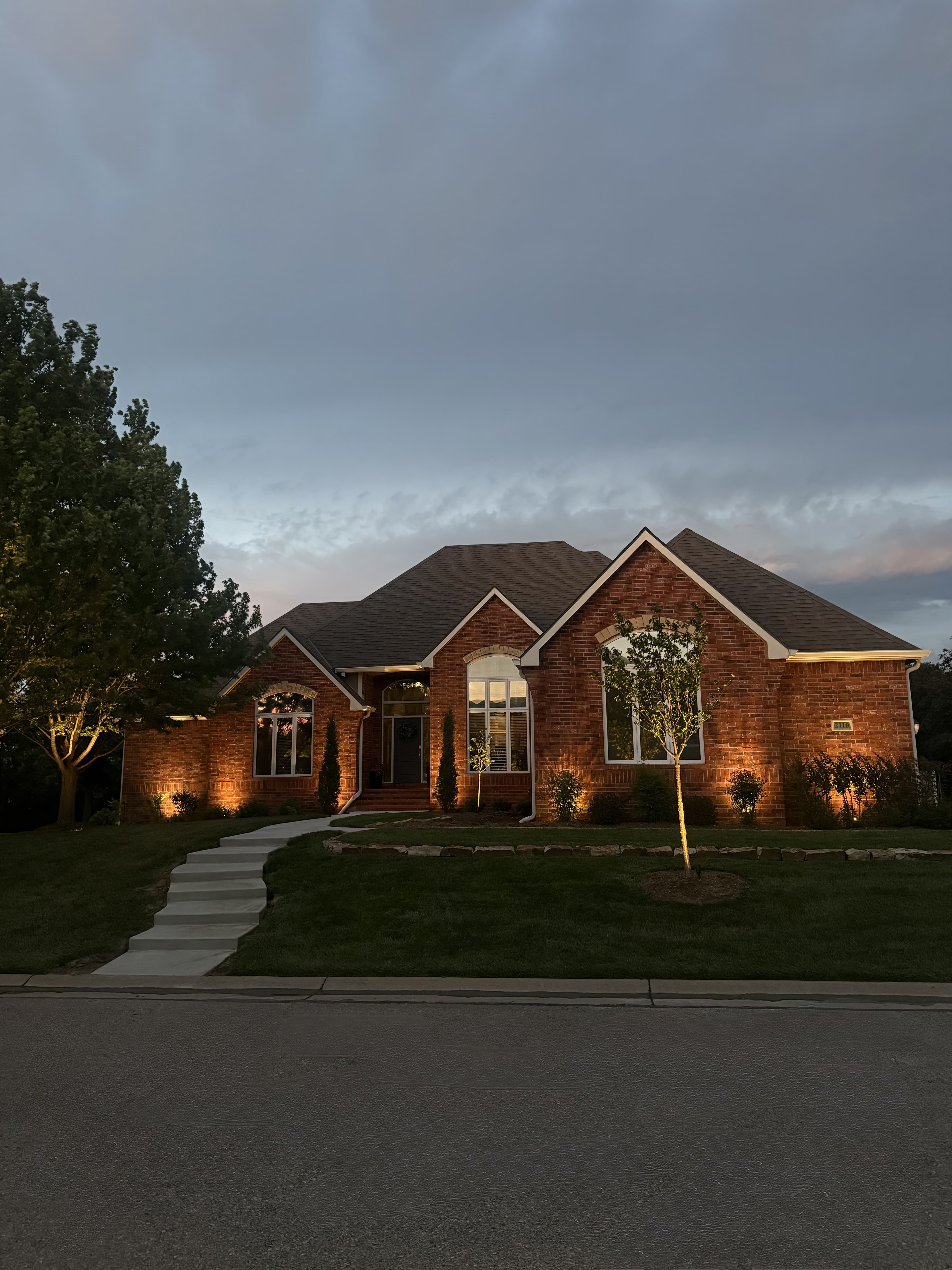 Oak Creek home with warm brick facade lighting